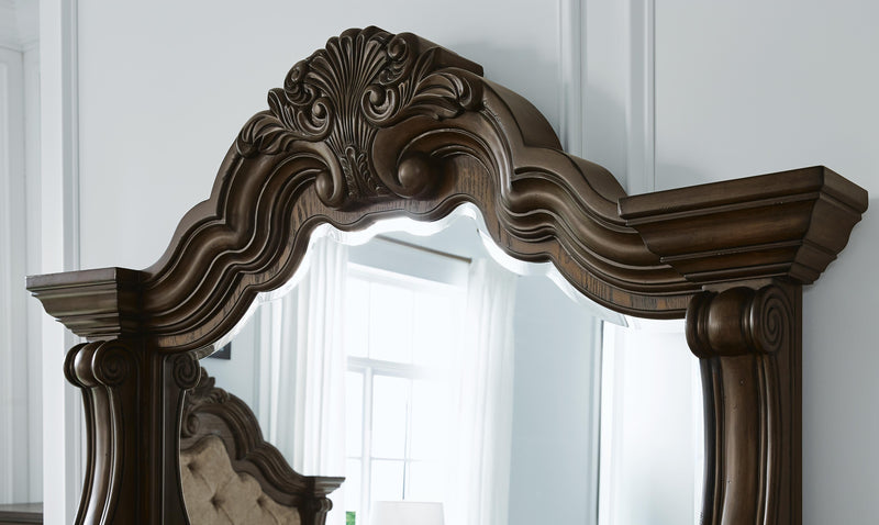 Detailed view of the Ashley Furniture Maylee Bedroom Set showcasing the elegant wood finish and classic design elements.
