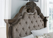 Ashley Furniture Maylee bedroom set with bed frame, matching nightstands, and dresser in a modern bedroom arrangement.