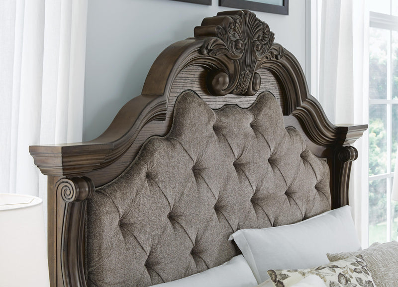 Ashley Furniture Maylee bedroom set with bed frame, matching nightstands, and dresser in a modern bedroom arrangement.