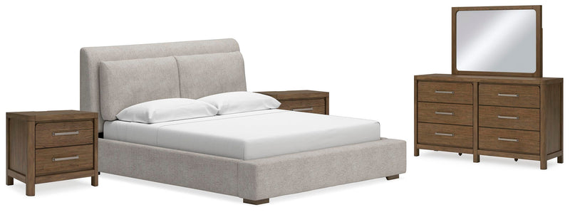 Ashley Furniture Cabalynn bedroom set with a bed, nightstands, and dresser in a modern design, shown in a cozy bedroom setting.