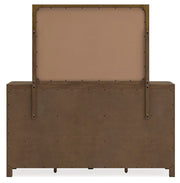 Cabalynn dresser with mirror by Ashley Furniture, featuring a wooden finish and classic design, shown from the back view.