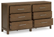 Ashley Furniture Cabalynn dresser with open drawers and wood finish, showcasing storage compartments and stylish design.
