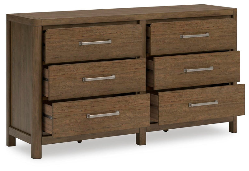 Ashley Furniture Cabalynn dresser with open drawers and wood finish, showcasing storage compartments and stylish design.