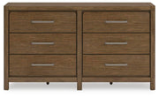 Cabalynn dresser by Ashley Furniture featuring a sleek wood finish and modern design with multiple drawers for ample storage.