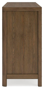 Ashley Furniture Cabalynn Dresser with sleek wood finish and multiple drawers, shown in a modern bedroom setting.