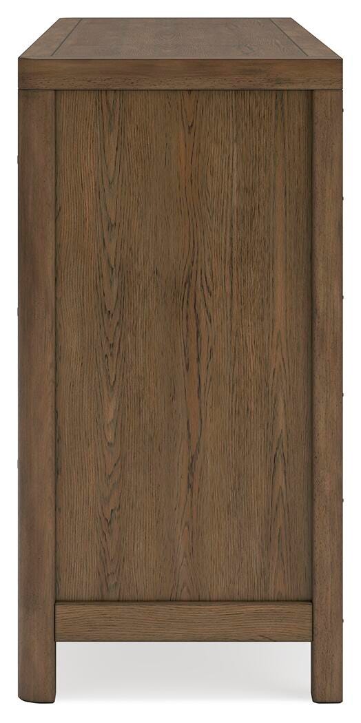Ashley Furniture Cabalynn Dresser with sleek wood finish and multiple drawers, shown in a modern bedroom setting.