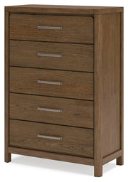 Ashley Furniture Cabalynn chest of drawers with a warm wood finish, angled view showing six spacious drawers and sleek modern design.