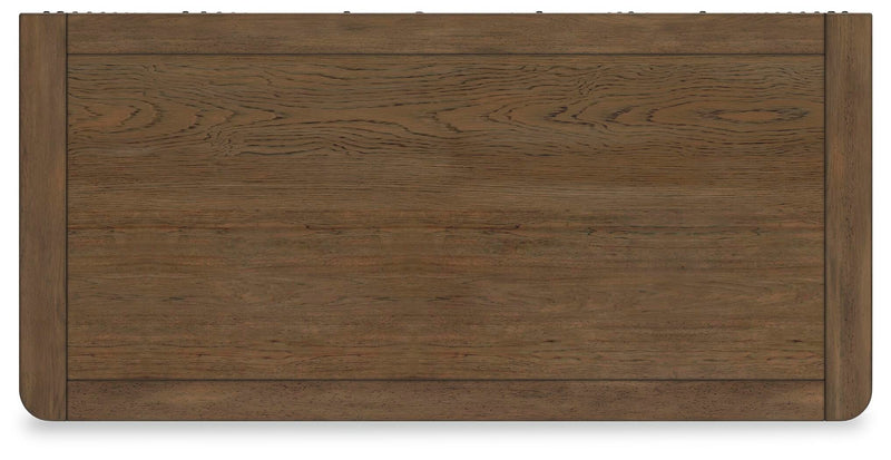 Ashley Furniture Cabalynn chest of drawers with a sleek wooden top and multiple storage drawers.