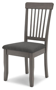Ashley Furniture Shullden dining room set with a wooden table and matching chairs, shown from an angled perspective.