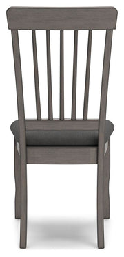 Ashley Furniture Shullden dining room set with a wooden table and matching chairs, shown from the back view.