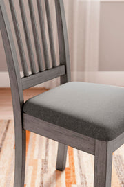 Ashley Furniture Shullden dining room set with a wooden table and matching chairs, displayed in a modern dining space.