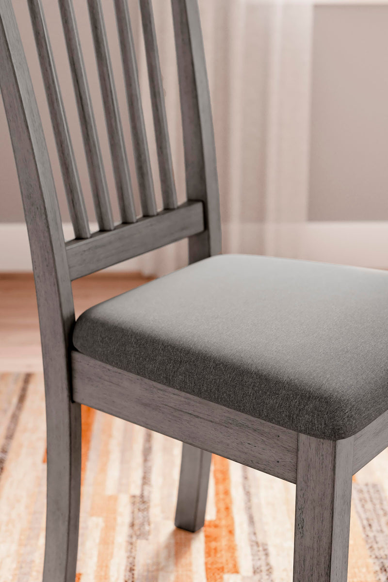 Ashley Furniture Shullden dining room set with a wooden table and matching chairs, displayed in a modern dining space.