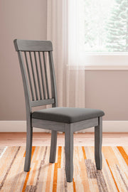 Ashley Furniture Shullden dining room set with a wooden table and matching chairs, ideal for family dinners.