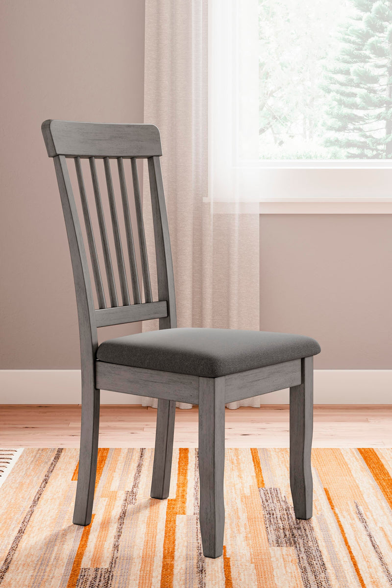 Ashley Furniture Shullden dining room set with a wooden table and matching chairs, ideal for family dinners.