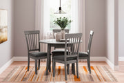 Ashley Furniture Shullden dining room set with a wooden table and six matching chairs in a modern dining space.