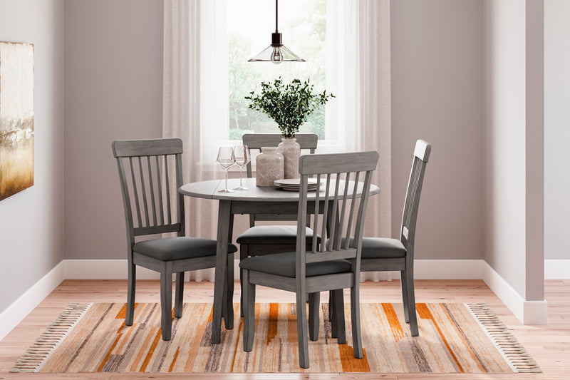 Ashley Furniture Shullden dining room set with a wooden table and six matching chairs in a modern dining space.