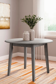 Ashley Furniture Shullden dining room set with a wood table and six matching chairs in a modern dining space.