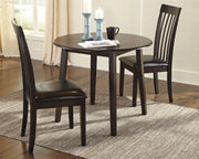 Ashley Furniture Hammis dining set with a rectangular table and six upholstered chairs in a modern dining room.