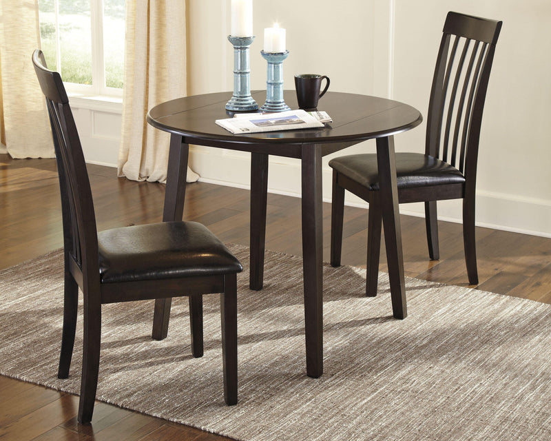 Ashley Furniture Hammis dining set with a rectangular table and six upholstered chairs in a modern dining room.