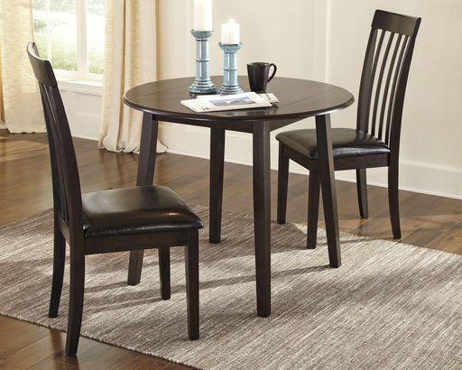 Ashley Furniture Hammis dining set with a rectangular table and six upholstered chairs in a modern dining room.