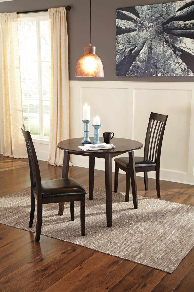Ashley Furniture Hammis dining set with oval table and six upholstered chairs in a modern dining room arrangement.