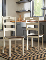 Ashley Furniture Woodanville dining chair set with four upholstered, wooden frame chairs in a warm finish.