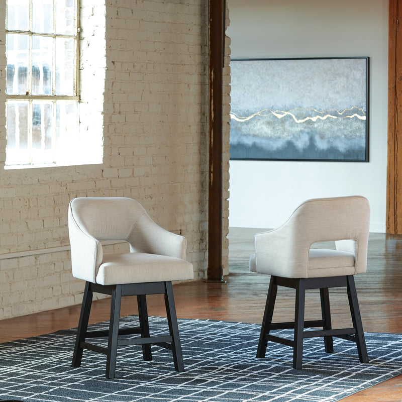 Ashley Furniture Tallenger Bar Stool Set featuring four modern wooden barstools with upholstered seats and metal footrests.