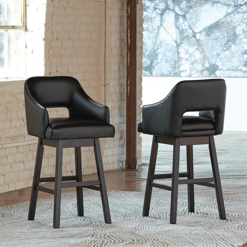 Ashley Furniture Tallenger bar stool set with four high-back wooden stools and metal footrests, ideal for kitchen or bar area.