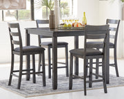 Ashley Furniture Bridson counter height dining table with four matching bar stools, showcasing a modern wood finish and sturdy design.