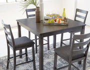 Ashley Furniture Bridson counter height dining table with four matching bar stools, showcasing a modern wood design and sturdy construction.