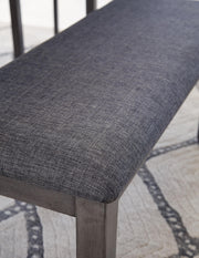Ashley Furniture Bridson dining table with matching chairs and bench, showcasing a stylish wood finish and modern design.