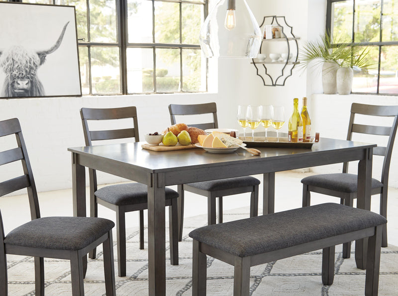 Ashley Furniture Bridson dining table with matching chairs and bench, showcasing a modern wood dining set for family meals.
