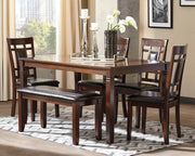 Ashley Furniture Bennox dining table with six matching chairs and a bench, showcasing a modern wood dining set.
