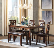 Ashley Furniture Bennox dining table with six matching chairs and a bench, showcasing a modern wood finish and spacious design.