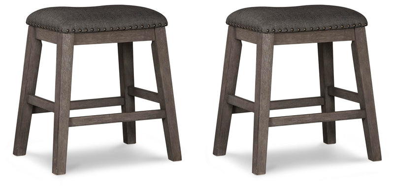 Set of Ashley Furniture Caitbrook counter height barstools with dark wood finish and upholstered seats, arranged around a dining table.