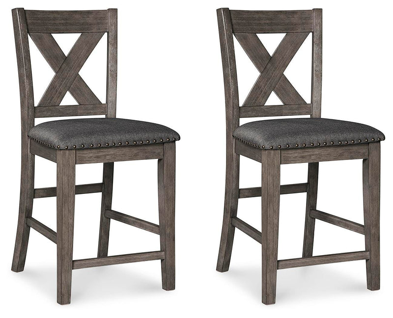 Set of Ashley Furniture Caitbrook counter height barstools with wooden seats and metal frames, arranged around a dining table.