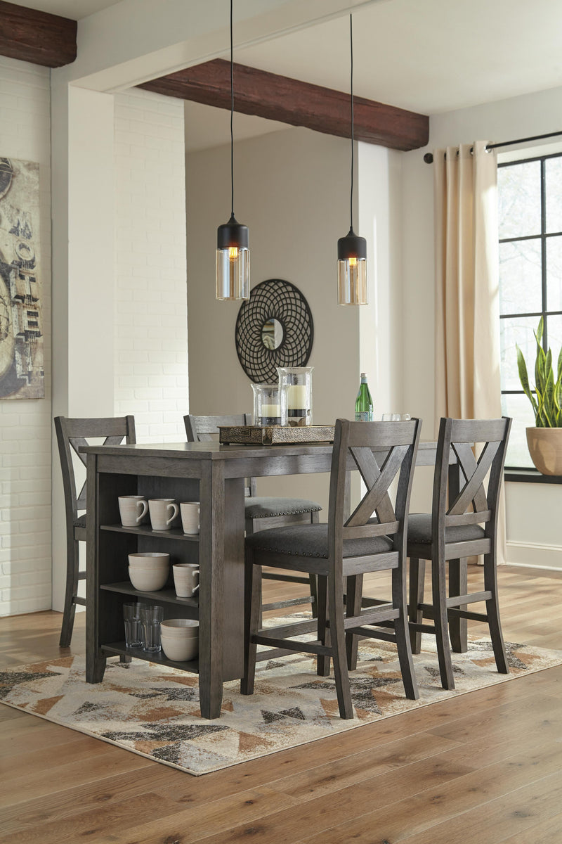 Ashley Furniture Caitbrook counter height upholstered bar stool with padded seat and wooden legs, shown in a modern dining setting.