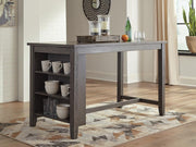 Set of four Ashley Furniture Caitbrook counter height barstools with wooden legs and upholstered seats, arranged around a dining table.