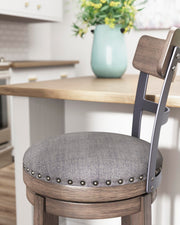 Ashley Furniture Caitbrook bar height bar stool with wooden legs and upholstered seat, detailed close-up image.