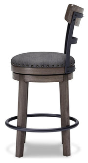 Ashley Furniture Caitbrook counter height bar stool with wooden legs and cushioned seat, shown from a side angle.