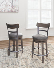 Ashley Furniture Caitbrook counter height bar stool with wooden legs and cushioned seat, shown in a modern kitchen setting