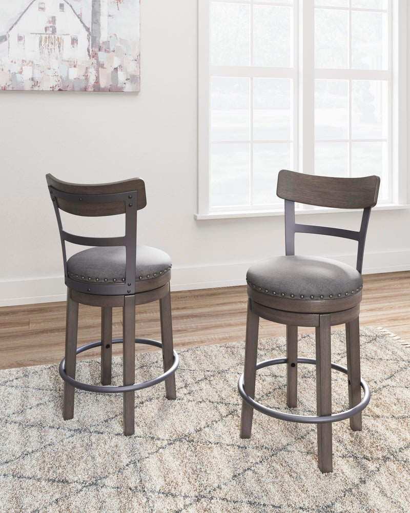 Ashley Furniture Caitbrook counter height bar stool with wooden legs and cushioned seat, shown in a modern kitchen setting