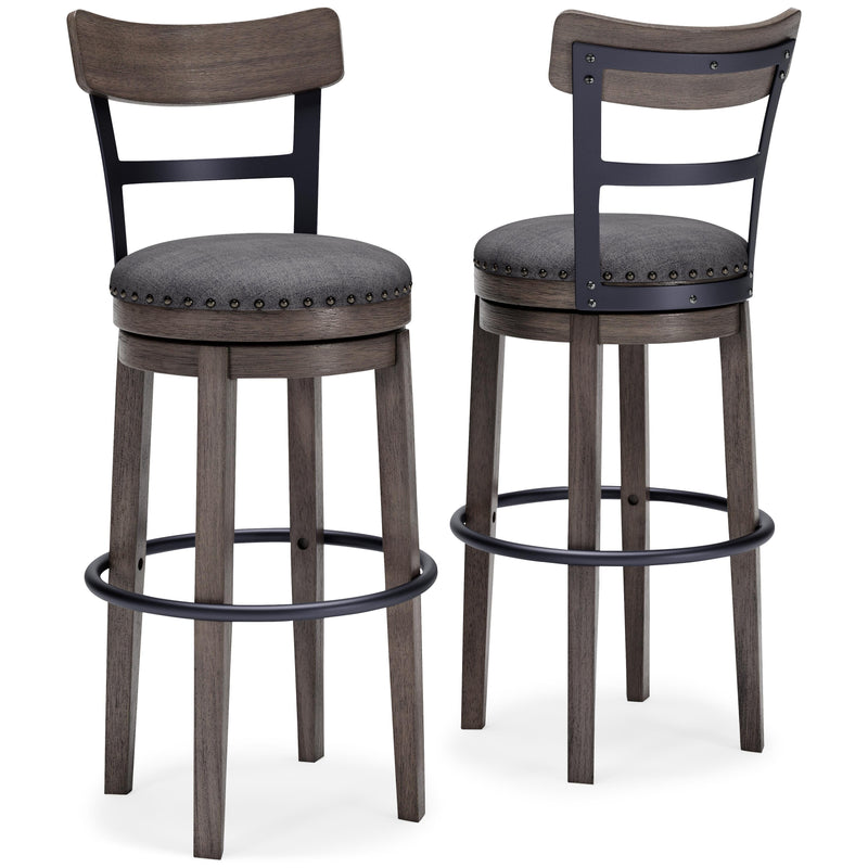 Ashley Furniture Caitbrook bar height bar stool with wooden frame and cushioned seat, shown in a modern kitchen setting.