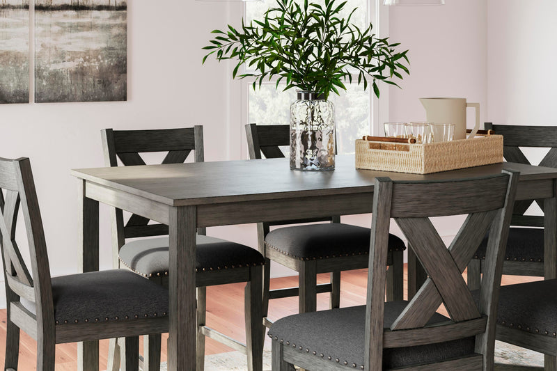Ashley Furniture Caitbrook counter height dining table with six matching bar stools, showcasing a modern wood finish and sturdy design.