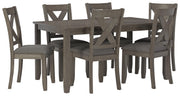 Ashley Furniture Caitbrook dining table with six matching chairs, featuring a classic wooden design and angled view.