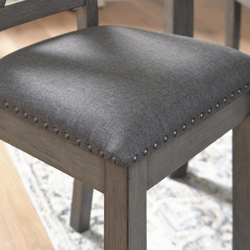 Ashley Furniture Caitbrook dining table with six matching chairs featuring nailhead trim, wood finish, and classic design.