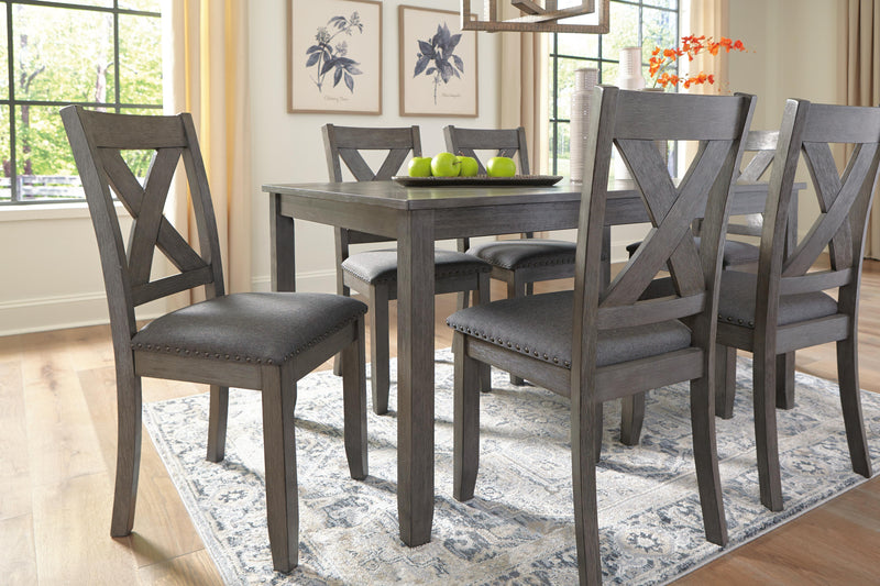 Ashley Furniture Caitbrook dining table with six matching chairs, showcasing a classic wood finish and elegant design.