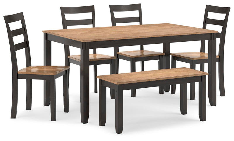 Ashley Furniture Gesthaven dining table with four matching chairs and a bench, shown from an angled view.