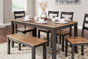 Ashley Furniture Gesthaven dining table with four chairs and a bench, showcasing a stylish wood finish and modern design.