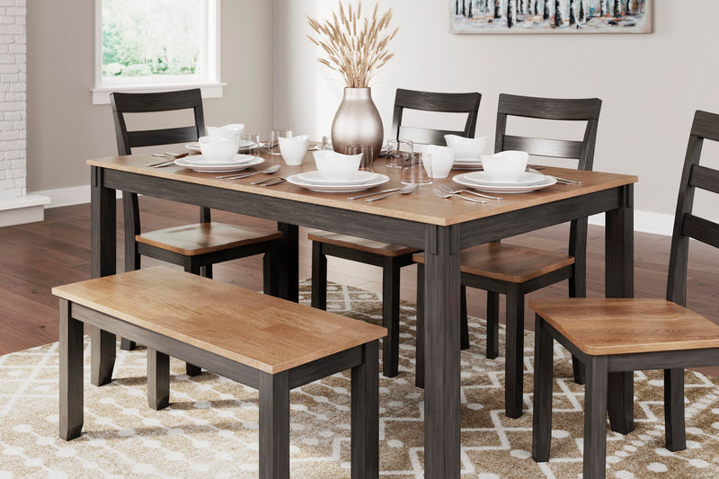 Ashley Furniture Gesthaven dining table with four chairs and a bench, showcasing a stylish wood finish and modern design.